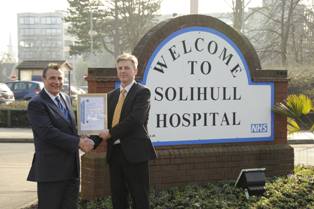 Solihull Hospital facilities environmental representative, Andy Cooke is presented the ISO14001 certificate by Keith Stanton from NQA